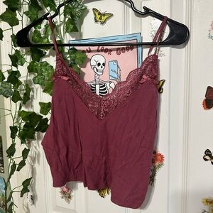 A lace tank top with some bows on it